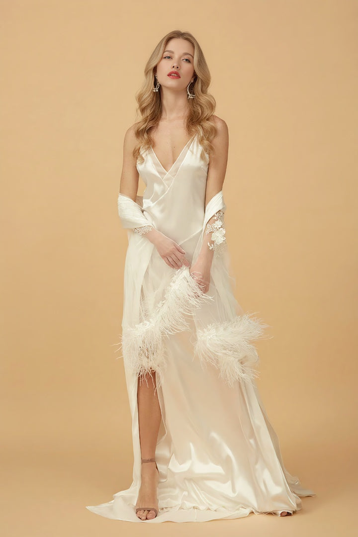 Woman wearing a white satin nightgown with lace details on a beige background